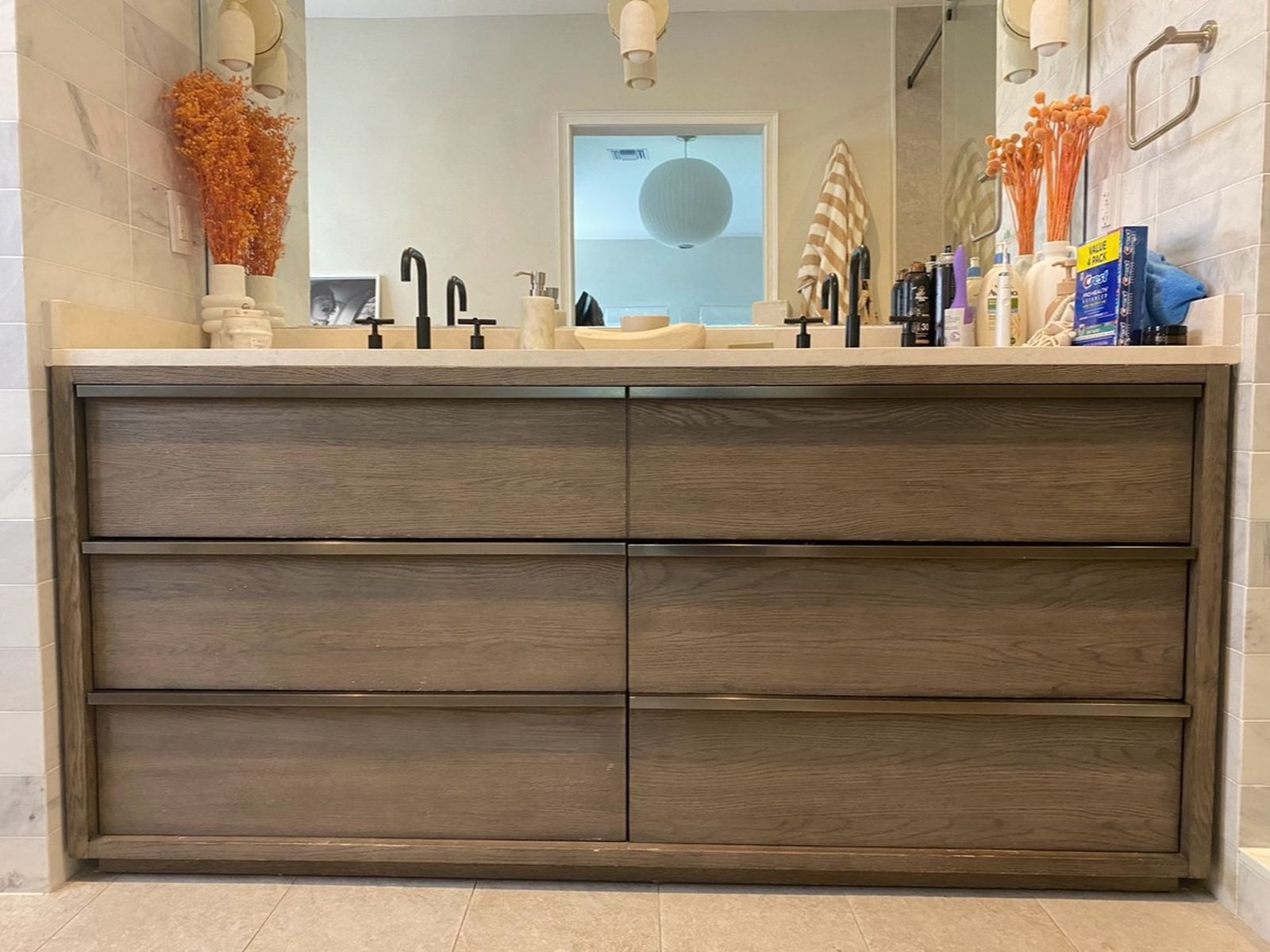 Primary bath vanity before resurfacing, dark walnut drawer fronts and frame