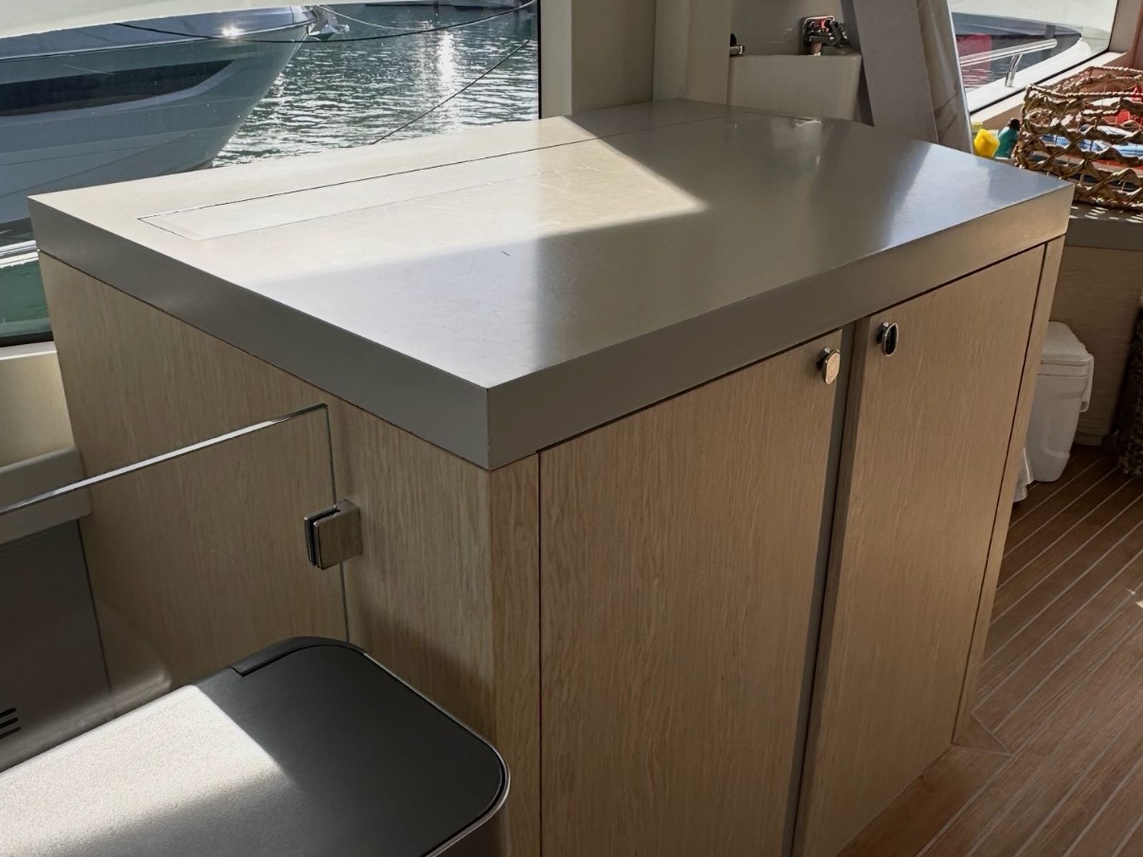 Yacht galley countertop before resurfacing, plain cream solid surface